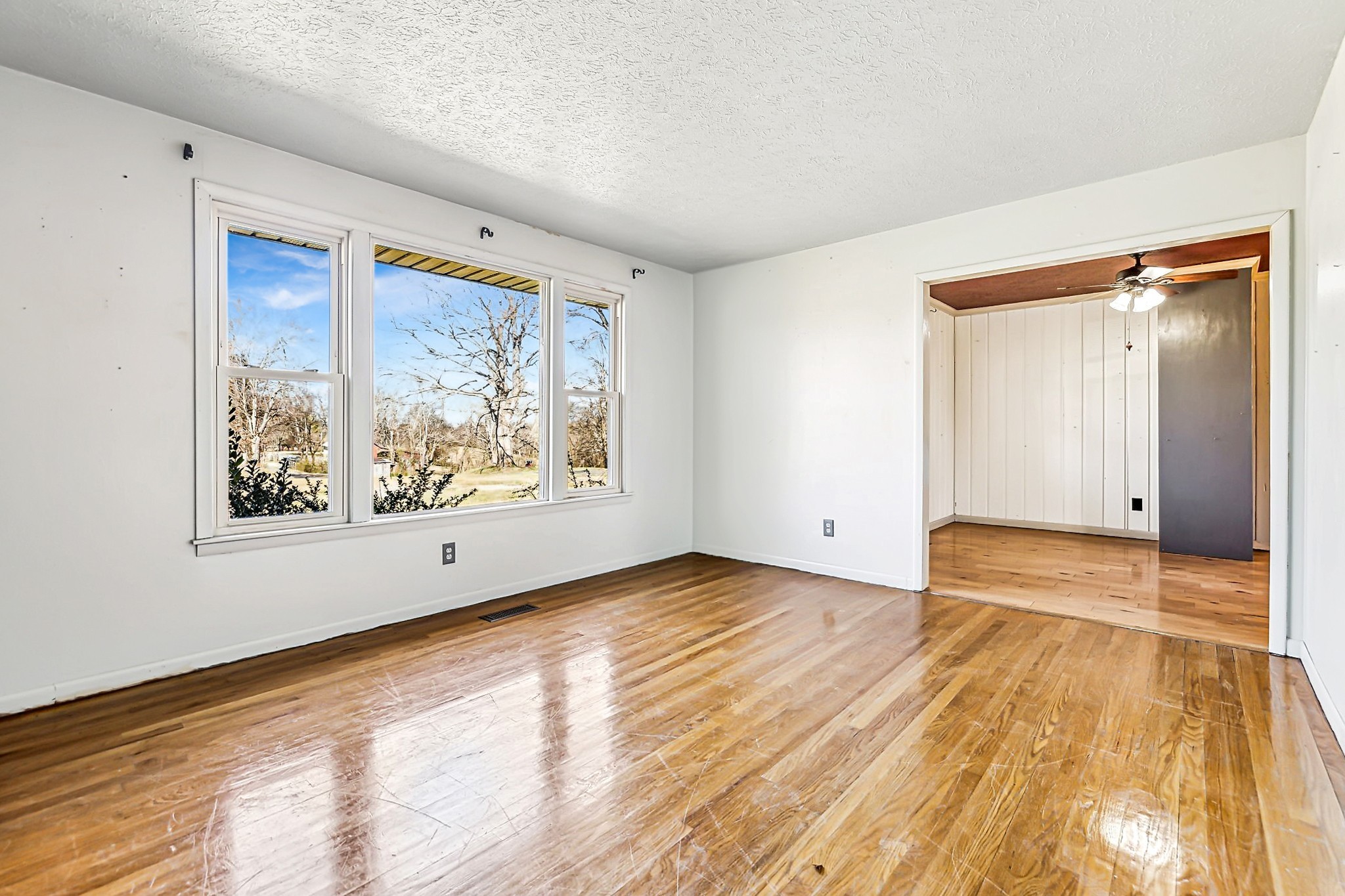 1170 Jim Read Road Ashland City, TN 37015 - Photo 6 of 39 a view of an empty room with wooden floor and a window