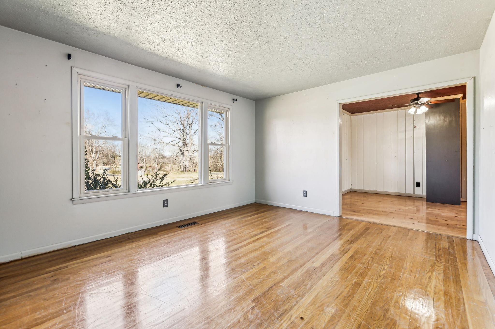 1170 Jim Read Road Ashland City, TN 37015 - Photo 7 of 39 a view of an empty room with wooden floor and a window