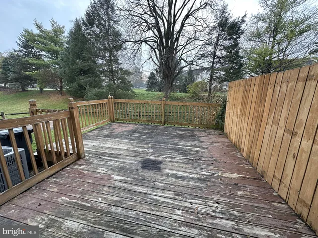 a view of deck with wooden floor and fence next to a lake