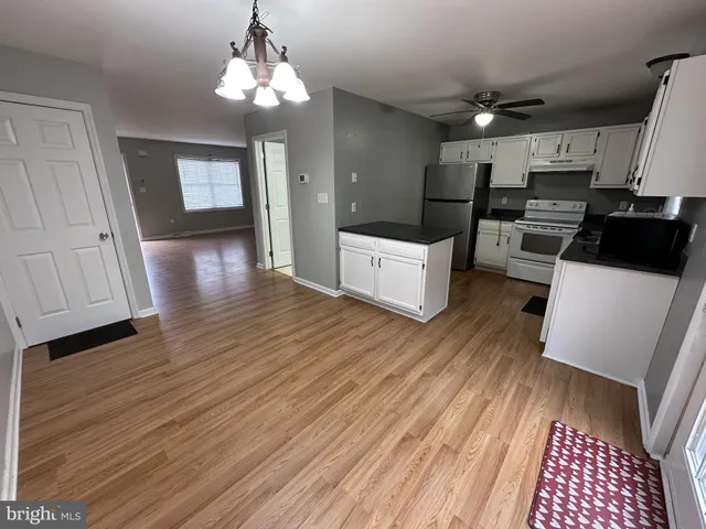 a large room with wooden floor and furniture