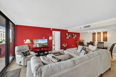 a living room with furniture a lamp and a flat screen tv
