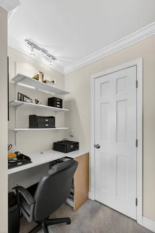 a view of walk in closet with empty racks