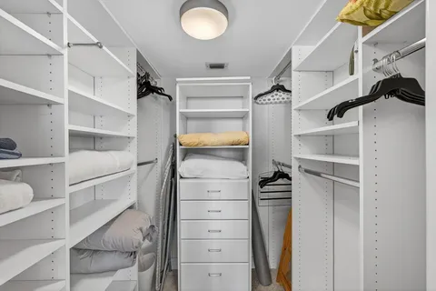 a bathroom with a granite countertop tub sink and mirror