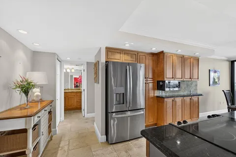 a kitchen with a refrigerator and a sink