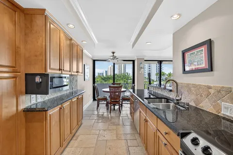 a kitchen with stainless steel appliances granite countertop a sink stove and cabinets