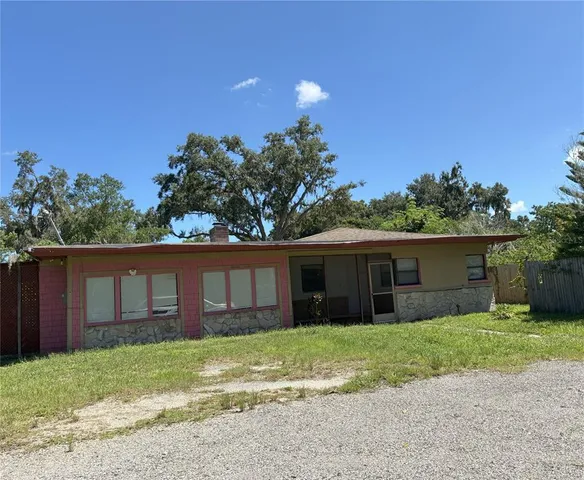a front view of a house with a garden and yard