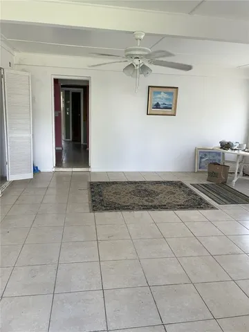 a view of a livingroom with furniture and an entryway