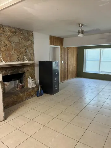 a view of a livingroom with a fireplace and window