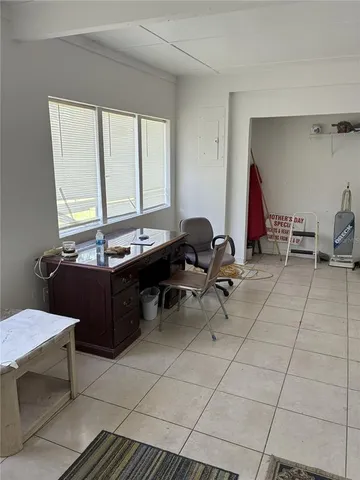 a room with a table chairs and a window