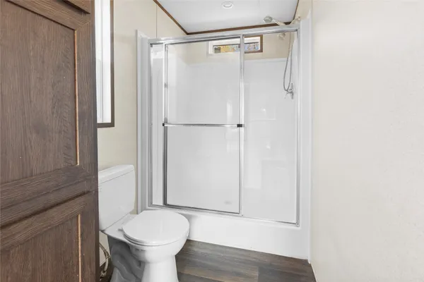 a view of a room with wooden floor