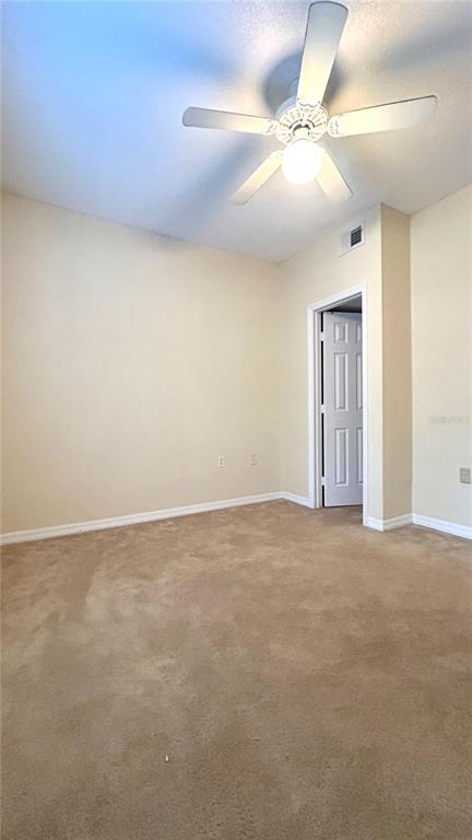 10000 Southwest 52nd Avenue, Unit 7 Gainesville, FL 32608 - Photo 12 of 24 a view of an empty room and chandelier fan