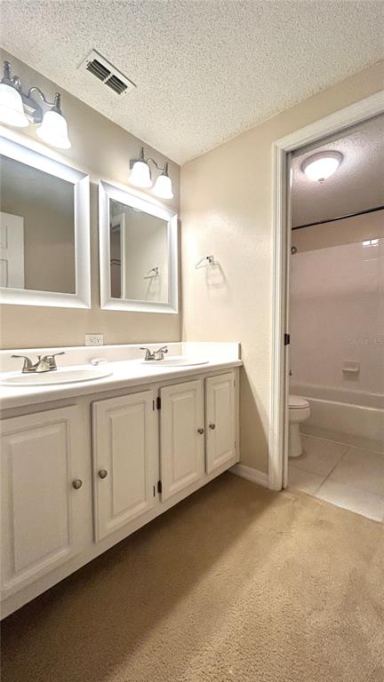 10000 Southwest 52nd Avenue, Unit 7 Gainesville, FL 32608 - Photo 13 of 24 a spacious bathroom with a double vanity sink a mirror and a bathtub