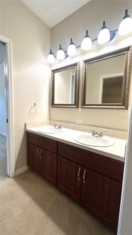 10000 Southwest 52nd Avenue, Unit 7 Gainesville, FL 32608 - Photo 21 of 24 a bathroom with a sink and a mirror