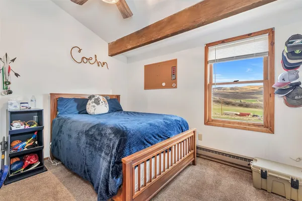 a bedroom with bed and a window
