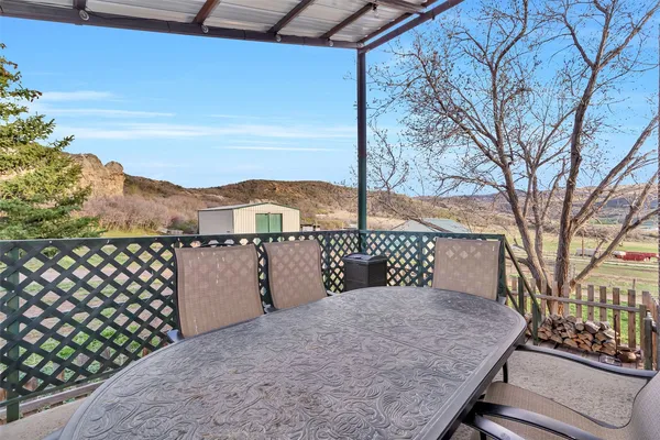 a view of a chairs and table in the patio
