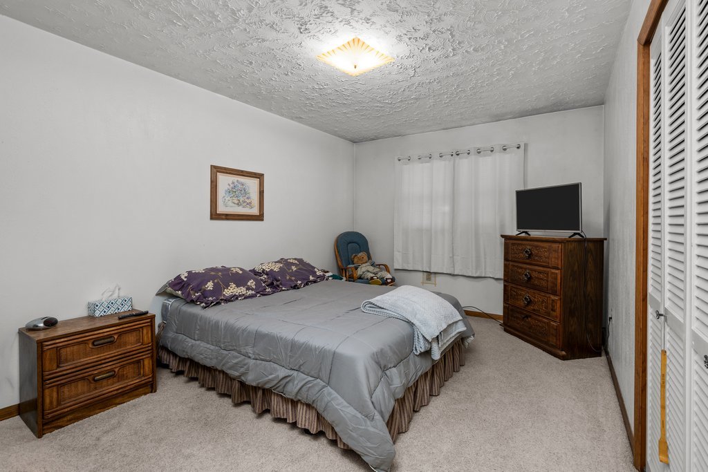 11213 22nd Street Milan, IL 61264 - Photo 7 of 36 a bedroom with a bed and a flat screen tv