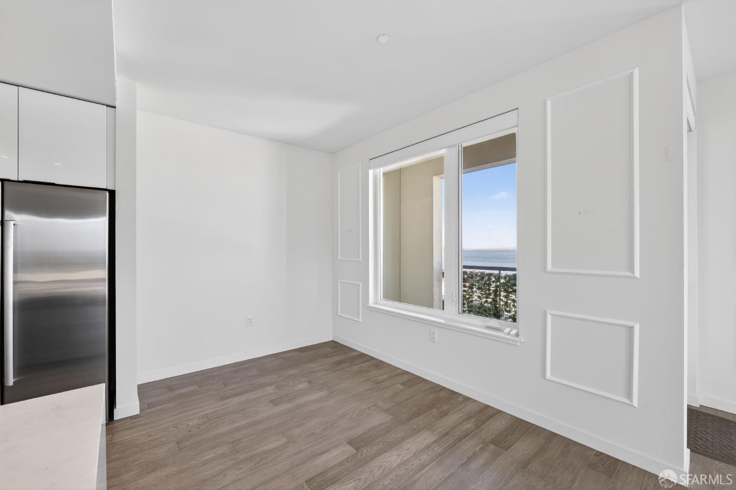 10 Innes Court, Unit 401 San Francisco, CA 94124 - Photo 8 of 33 an empty room with wooden floor and windows