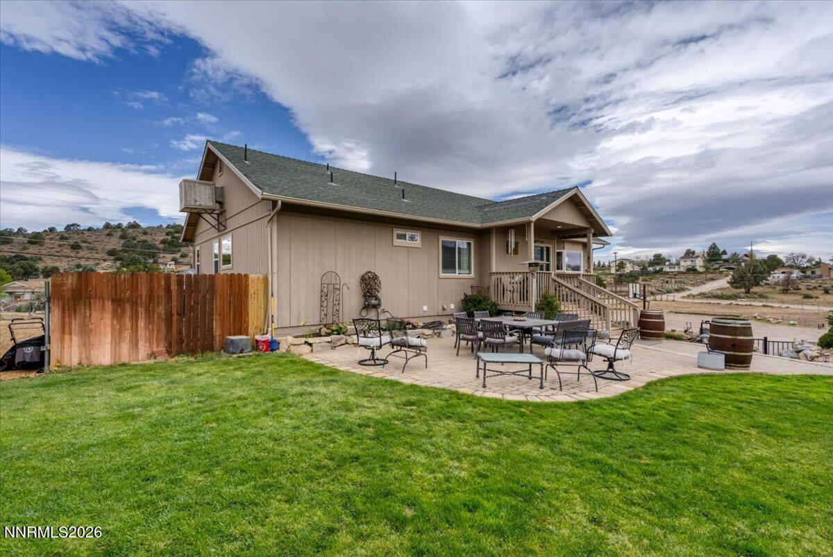 15770 Rocky Vista Road Reno, NV 89521 - Photo 37 of 68 a view of a patio with table and chairs with wooden fence