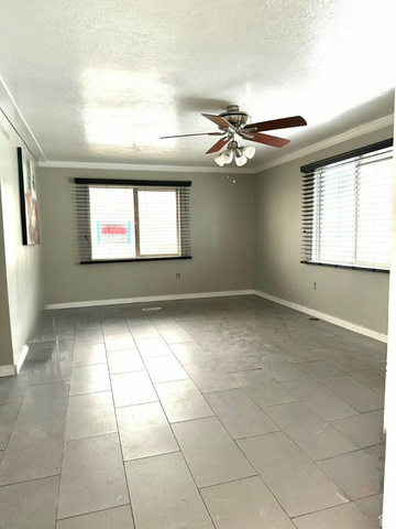 2491 Highway 89, Unit 114 Pleasant View, UT 84404 - Photo 8 of 18 Unfurnished room with crown molding, a textured ceiling, and ceiling fan