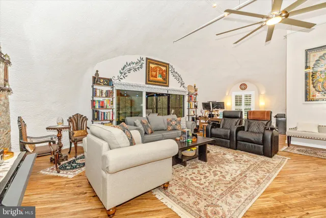 a living room with furniture wooden floor and a rug
