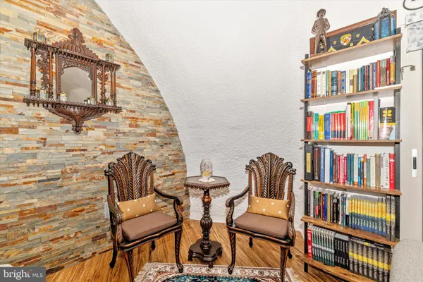 a view of a livingroom with furniture and staircase