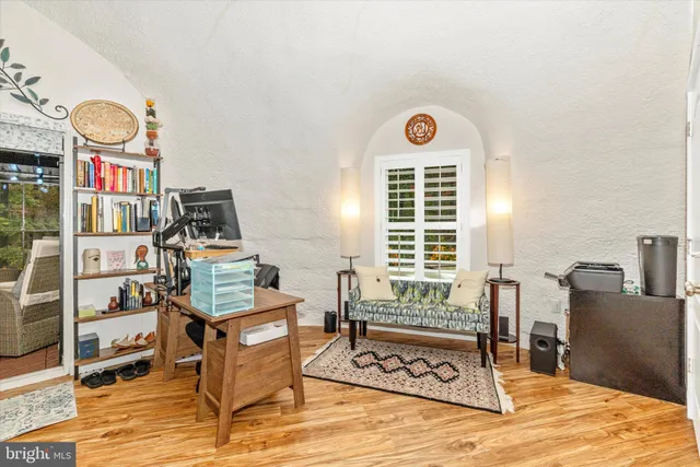 a view of a workspace with furniture and a window