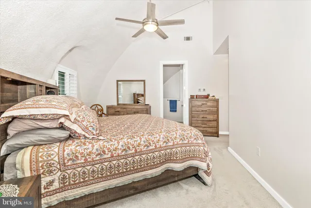 a bedroom with a bed and dresser