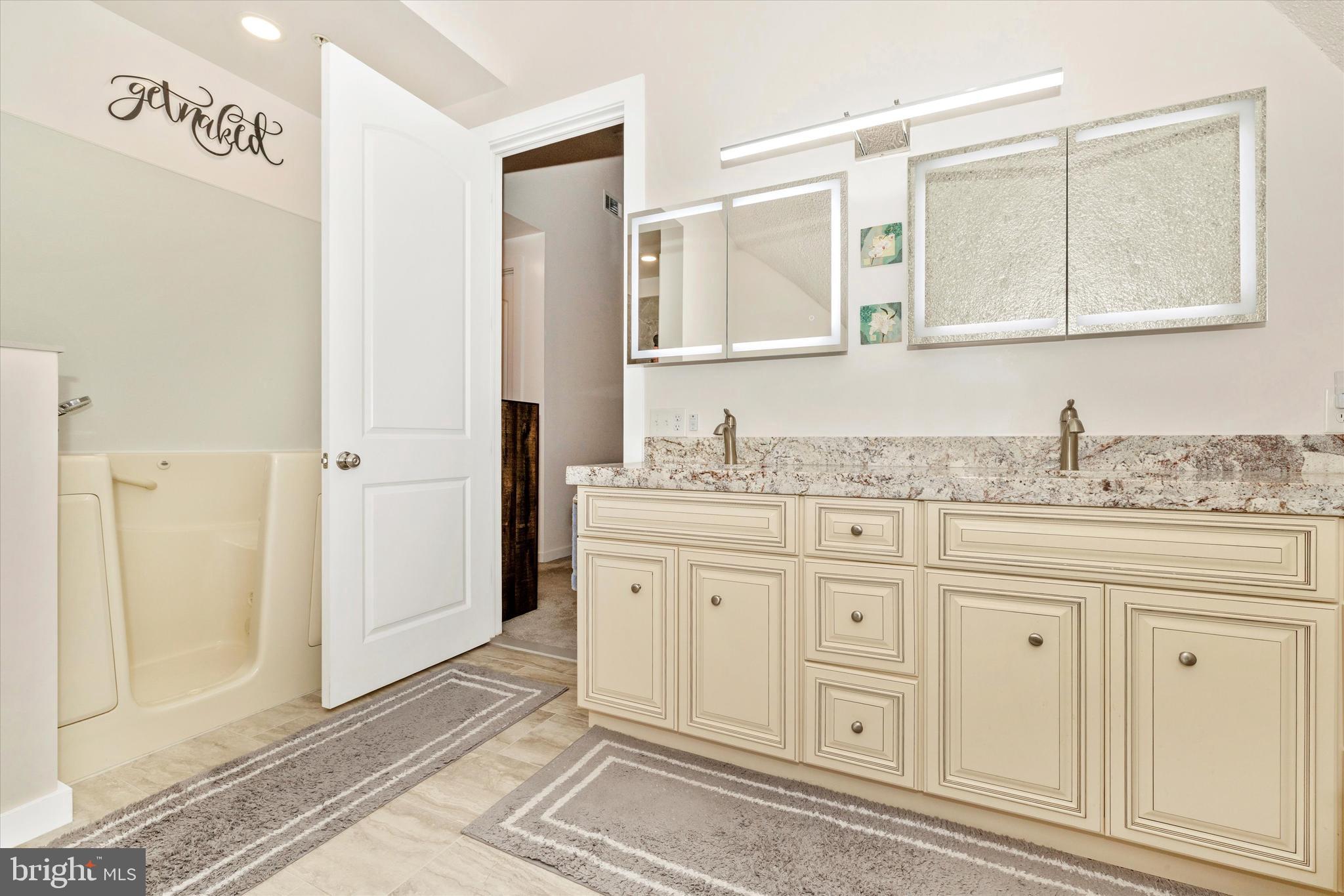 4940 Fox Tower Road Smithsburg, MD 21783 - Photo 21 of 41 a spacious bathroom with a granite countertop sink and a mirror