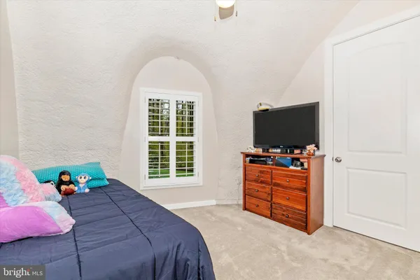 a living room with a bed furniture and a window