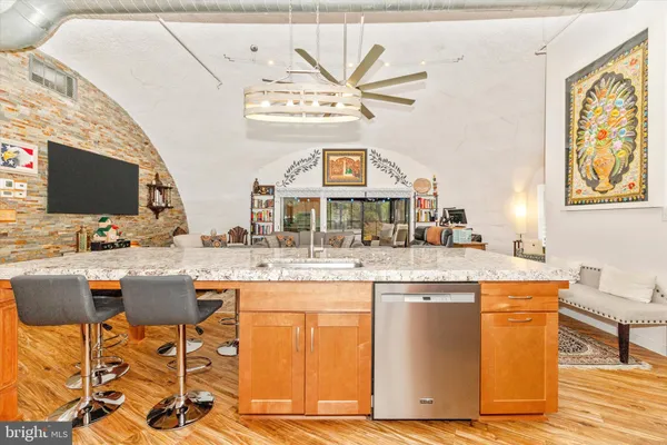 a kitchen with stainless steel appliances granite countertop a stove and a refrigerator