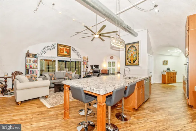 a view of a dining room with furniture a chandelier and wooden floor