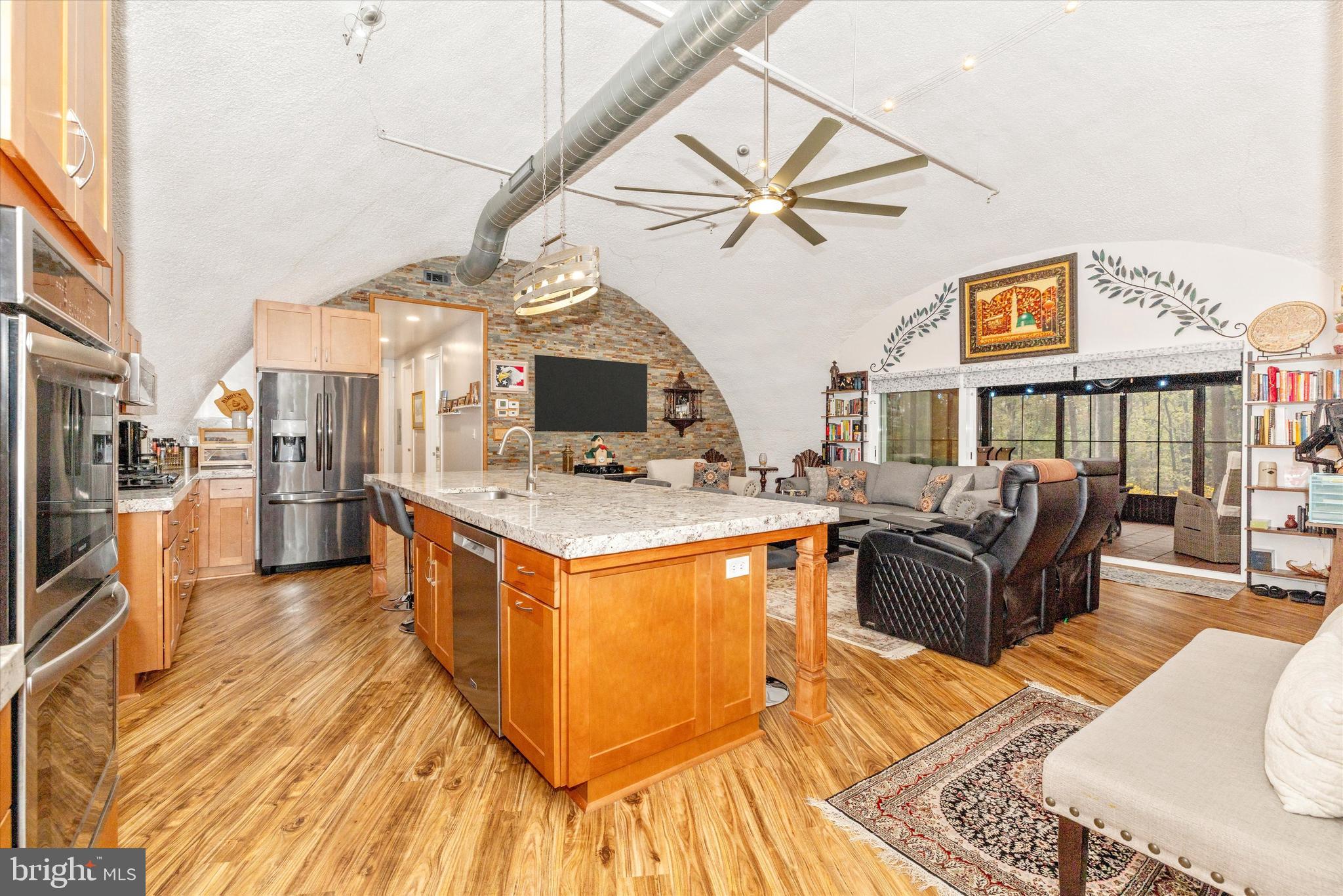 4940 Fox Tower Road Smithsburg, MD 21783 - Photo 9 of 41 a living room with stainless steel appliances kitchen island granite countertop wooden floor a dining table and chairs