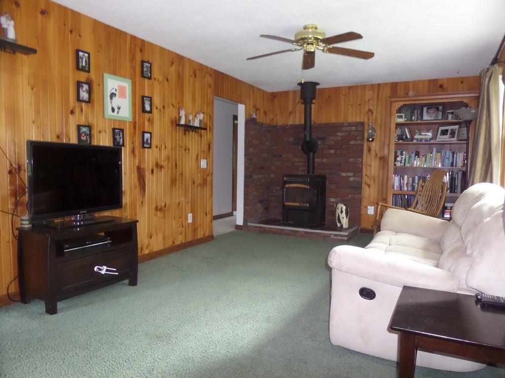 576 Main Road Eddington, ME 04428 - Photo 7 of 29 living room with newer pellet stove