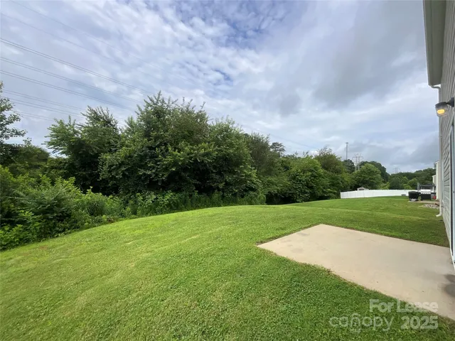 a view of a field and trees in the background