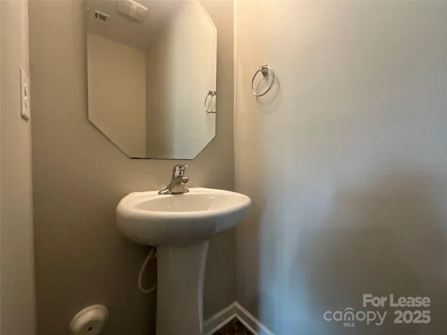 a bathroom with a sink a mirror and shower