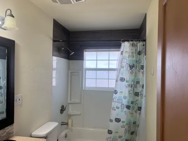 a view of a bedroom with wooden floor