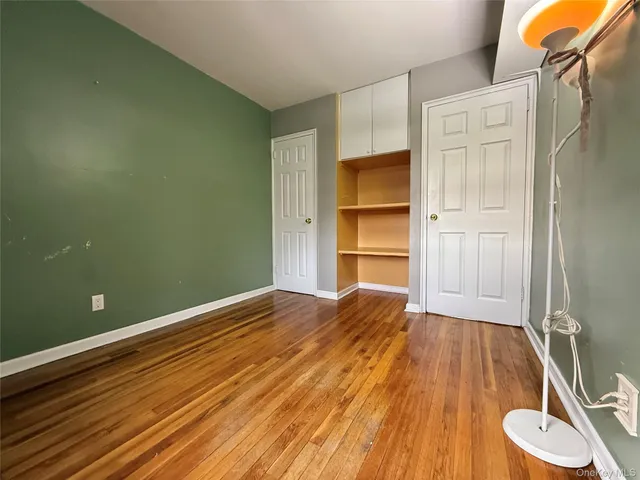 a room with wooden floor and window