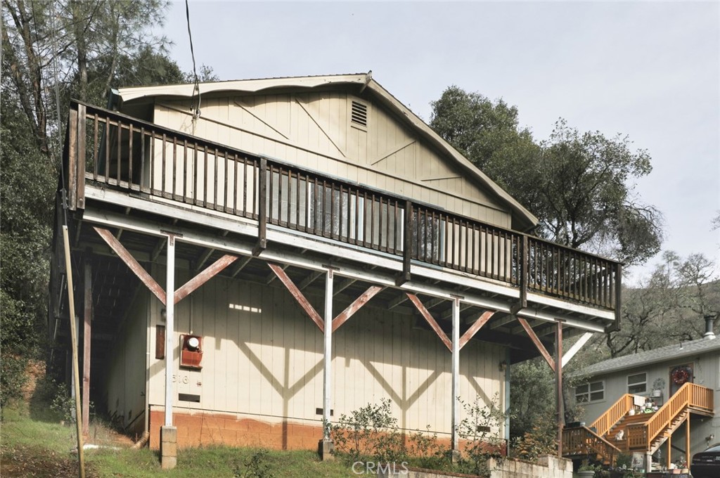 a roof deck with table and chairs