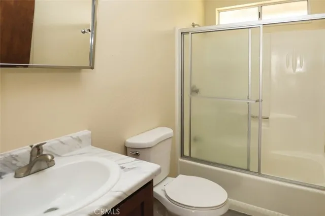 a white toilet sitting next to a bathroom sink