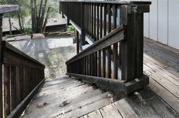 a view of wooden balcony with furniture