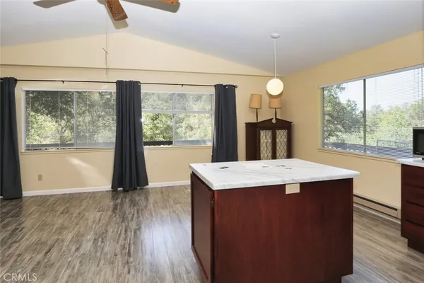 a view of a room with wooden floor and iron fence