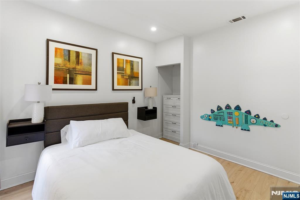 22 8th Avenue Newark, NJ 07104 - Photo 18 of 26 a bedroom with a bed and painting on the wall