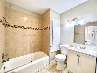 a bathroom with a granite countertop sink toilet a mirror and bathtub