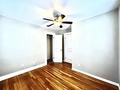 a bedroom with a bed and a ceiling fan