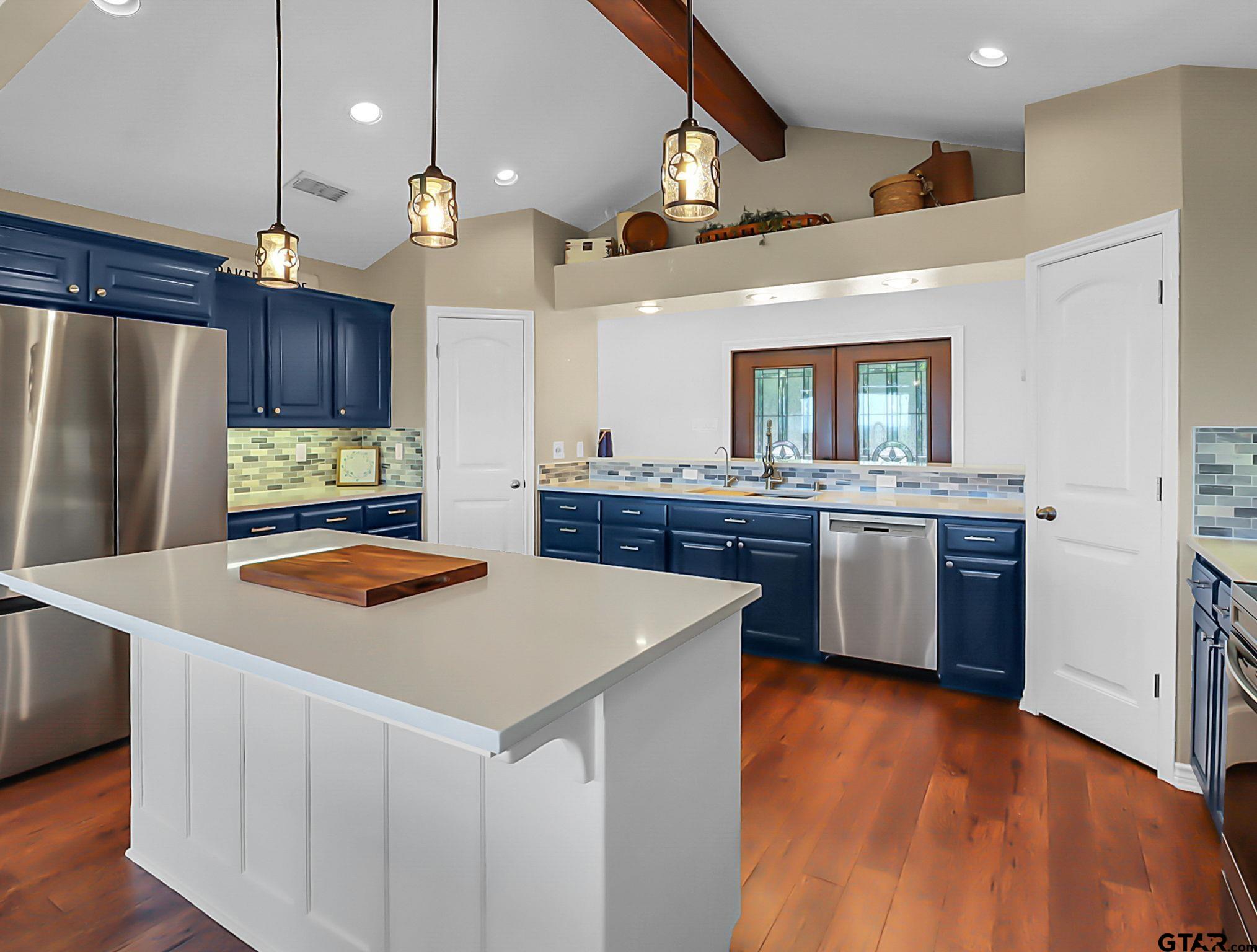307 Roesch Road Hallsville, TX 75650 - Photo 11 of 40 a kitchen with stainless steel appliances a sink a stove a refrigerator and cabinets