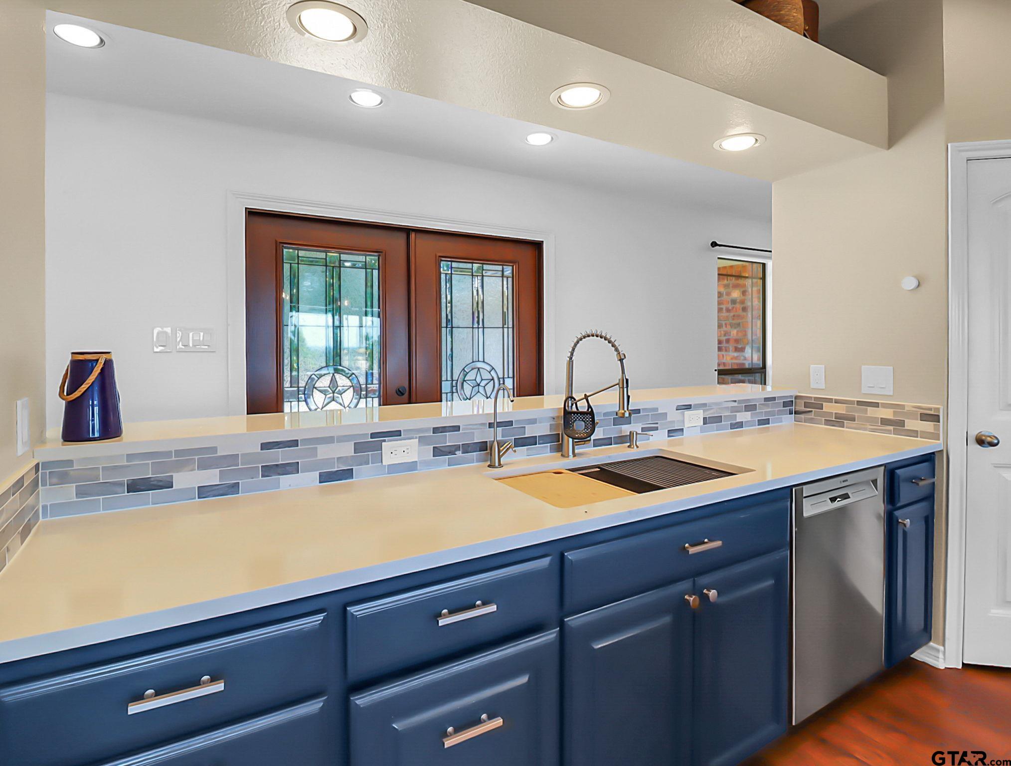 307 Roesch Road Hallsville, TX 75650 - Photo 15 of 40 a view of a kitchen with two sinks and large window