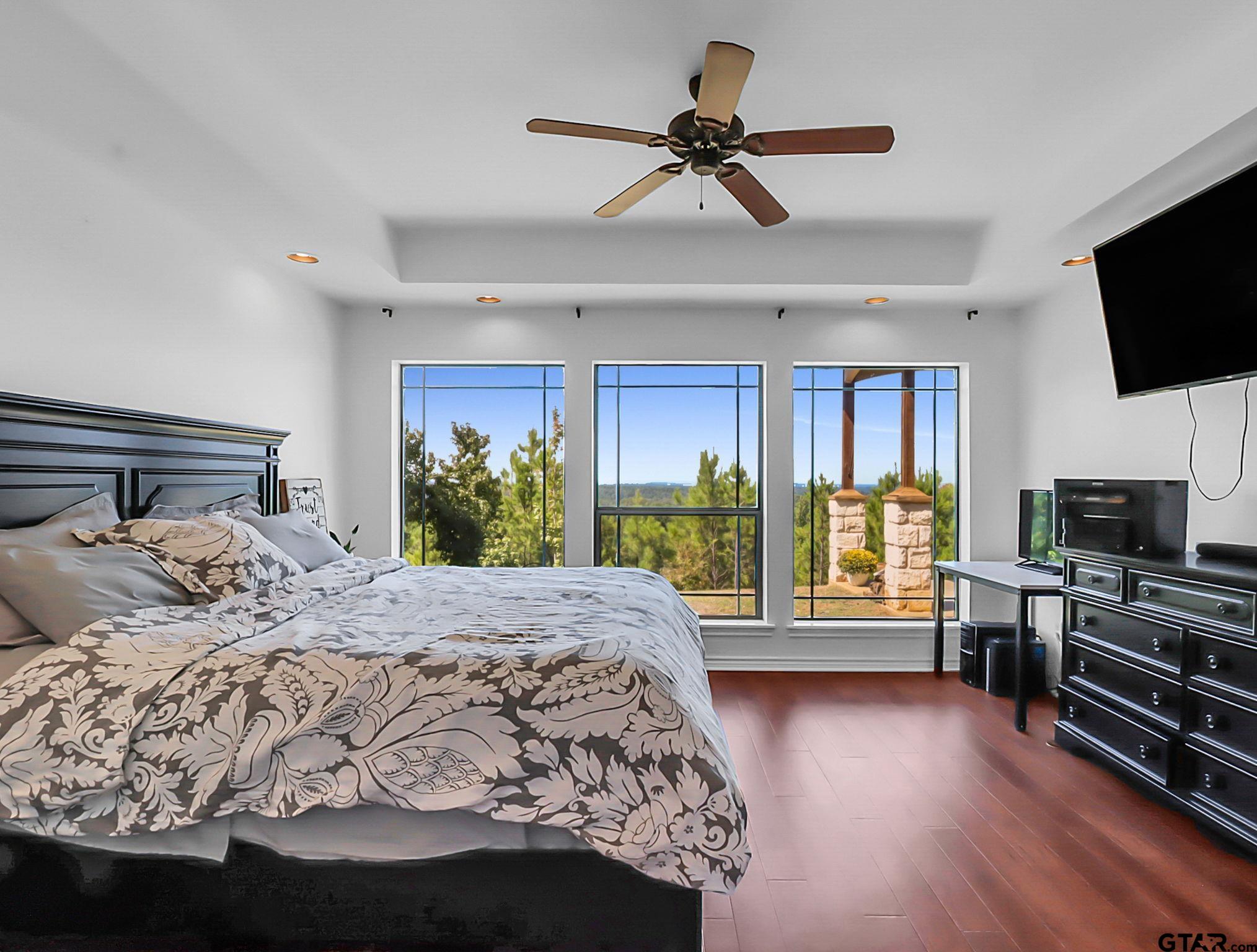 307 Roesch Road Hallsville, TX 75650 - Photo 16 of 40 a bedroom with a large bed a flat tv screen and dresser