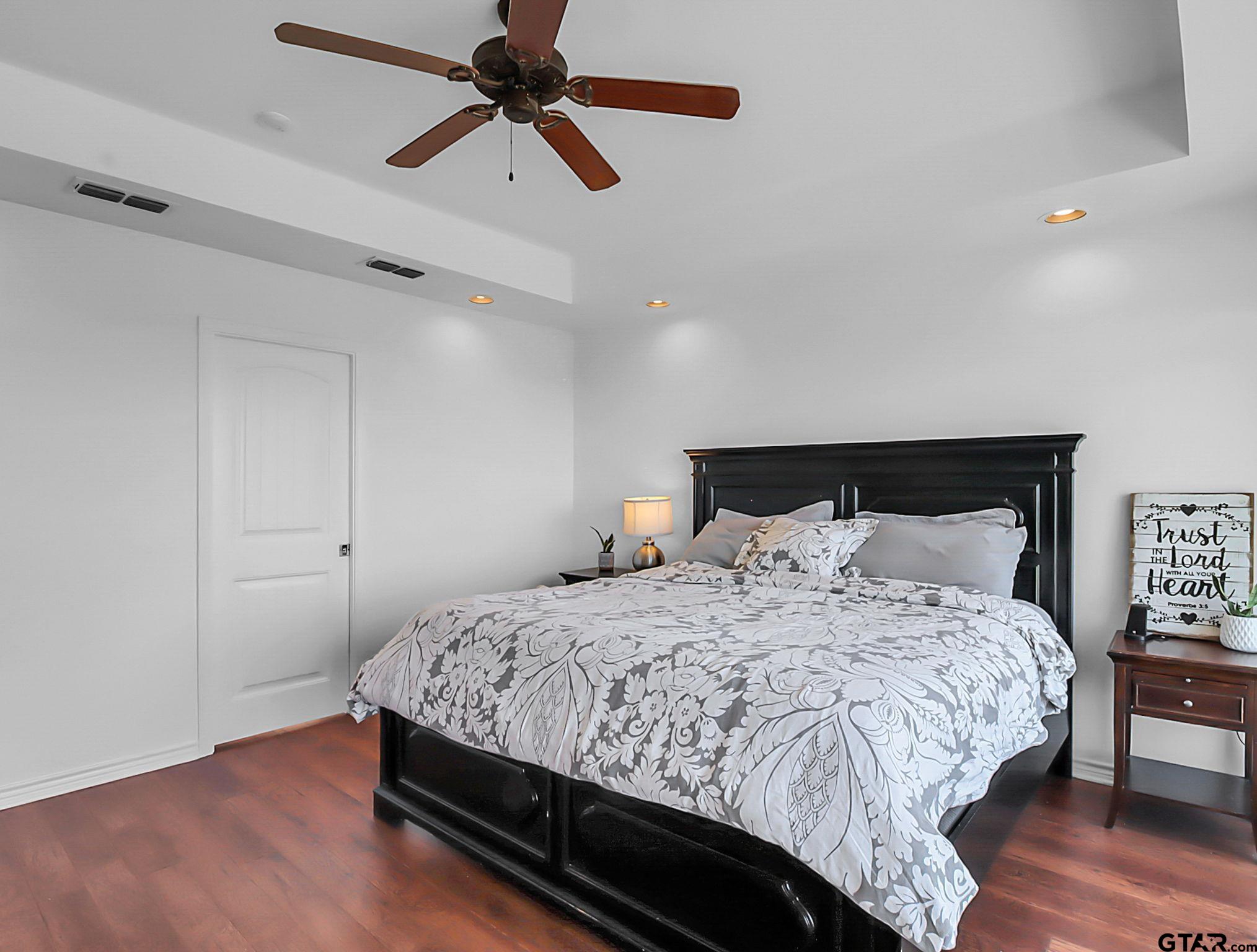 307 Roesch Road Hallsville, TX 75650 - Photo 17 of 40 a bedroom with a bed and wooden floor