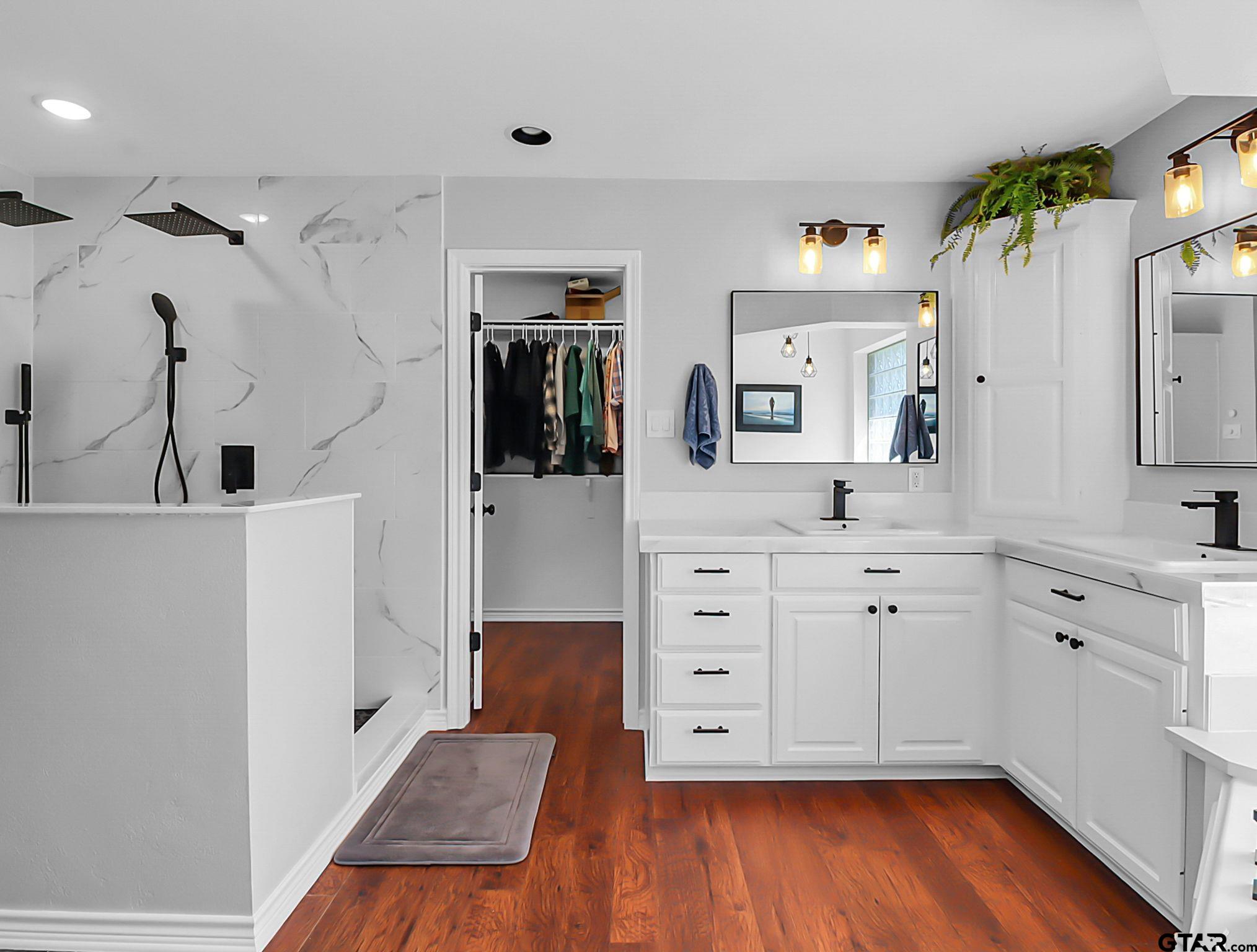 307 Roesch Road Hallsville, TX 75650 - Photo 18 of 40 a spacious bathroom with double vanity sink and mirror