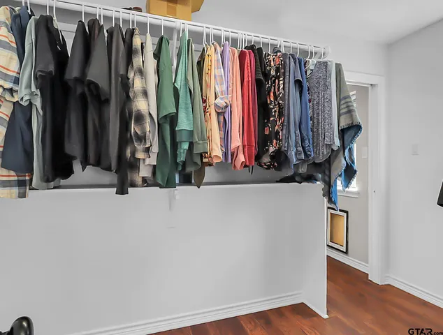a view of walk in closet with clothes